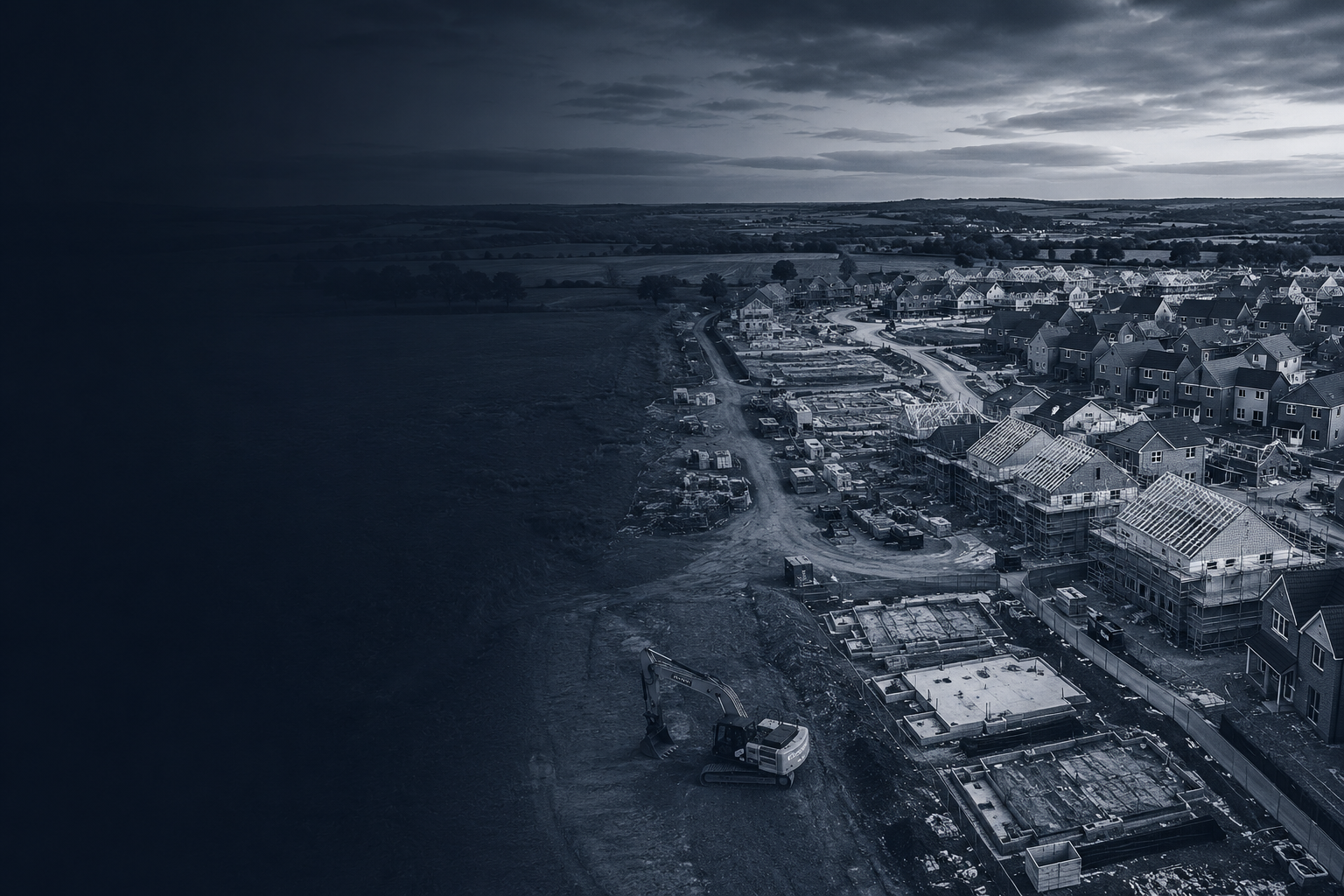Aerial view of a UK housing development site with foundations, excavator and new homes under construction
